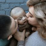 kissing a baby on the ear